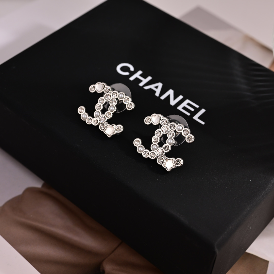 Chanel CC Logo Heart Star Crystal Pearl Stud Earrings earrings Silver-toned metal with clear crystals white faux pearls and mother-of-pearl heart and star accents 1 5cm width per earring