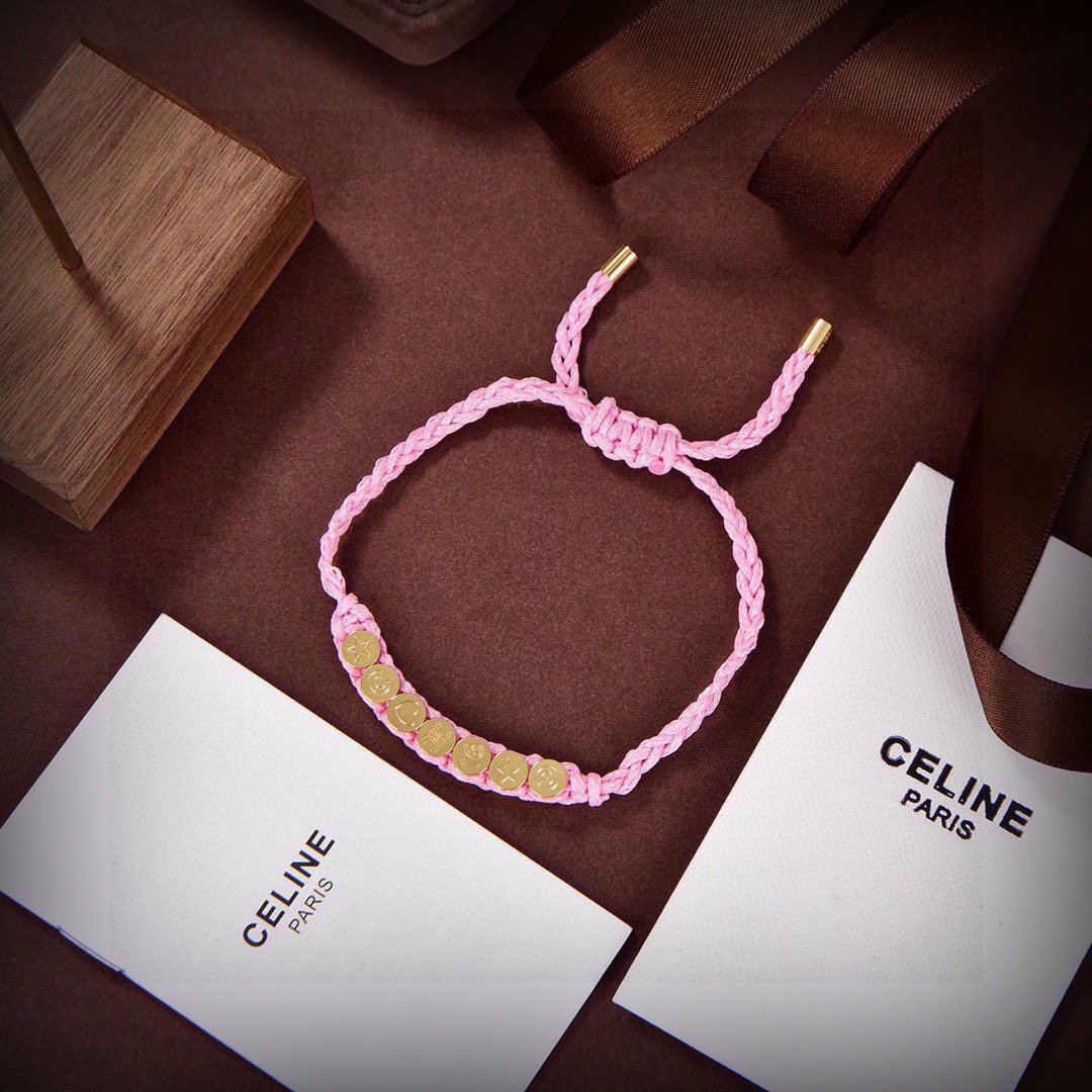 Celine PLAGE bracelet Pink braided cord with gold-tone metal charms and end caps Adjustable sliding knot fits 15-20cm wrist