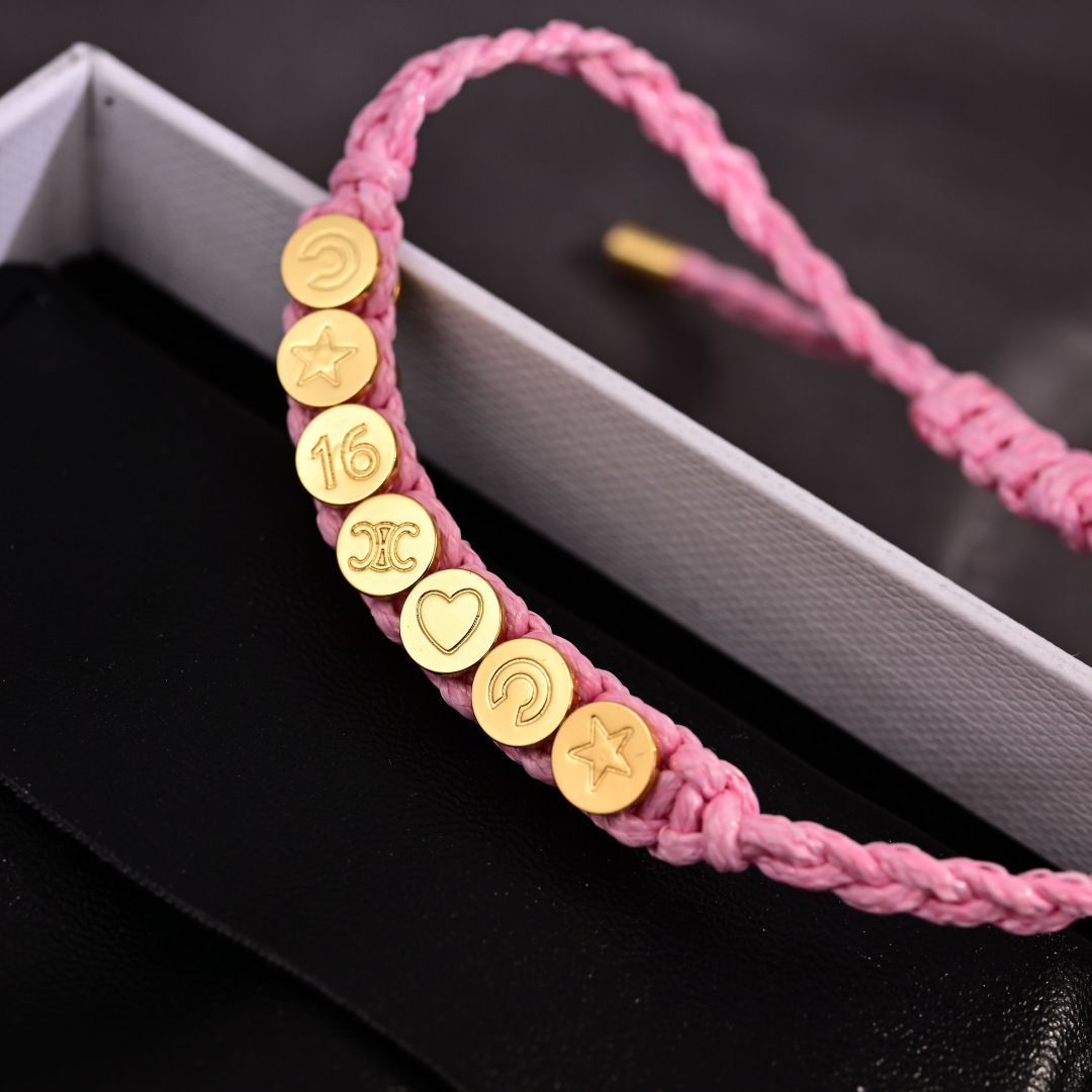 Celine PLAGE bracelet Pink braided cord with gold-tone metal charms and end caps Adjustable sliding knot fits 15-20cm wrist