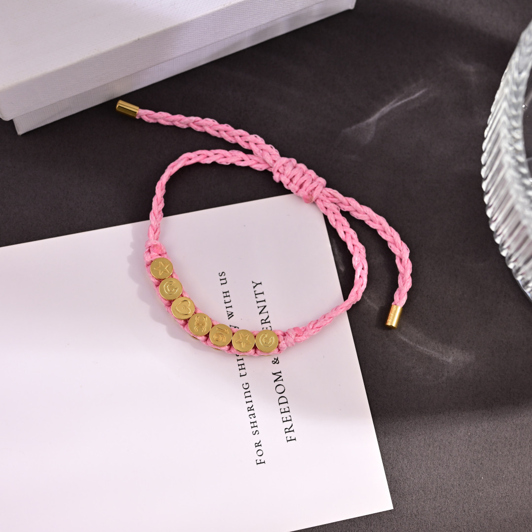 Celine PLAGE bracelet Pink braided cord with gold-tone metal charms and end caps Adjustable sliding knot fits 15-20cm wrist