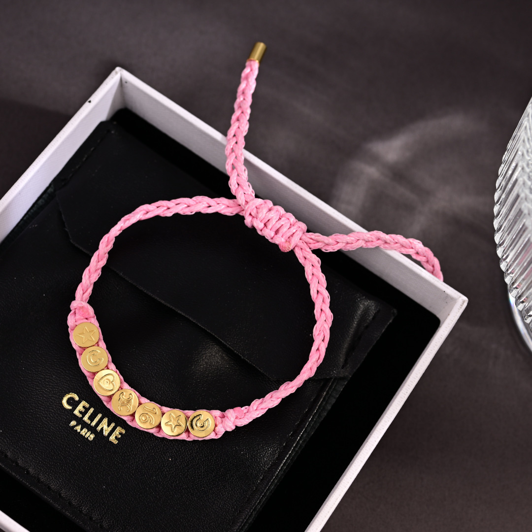 Celine PLAGE bracelet Pink braided cord with gold-tone metal charms and end caps Adjustable sliding knot fits 15-20cm wrist