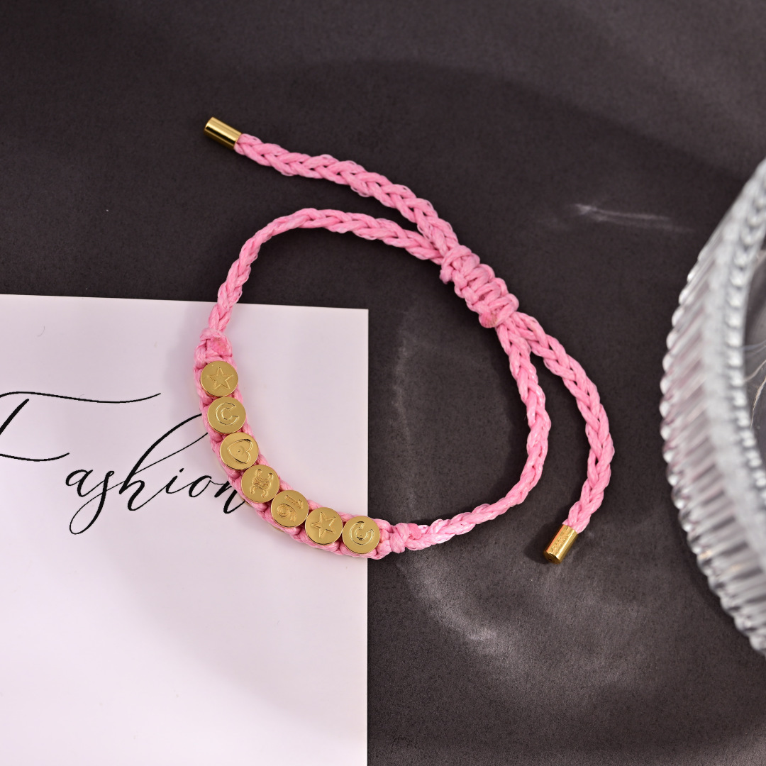 Celine PLAGE bracelet Pink braided cord with gold-tone metal charms and end caps Adjustable sliding knot fits 15-20cm wrist