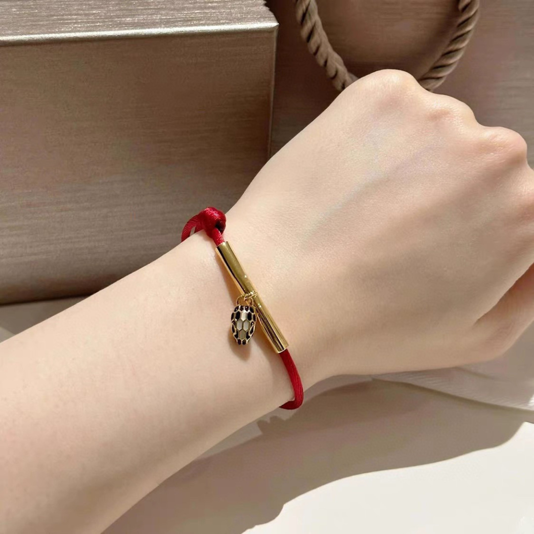 Bvlgari Serpenti Forever bracelet Gold-tone metal red cord black and white enamel snake head charm Adjustable red cord fits 15-19cm wrist