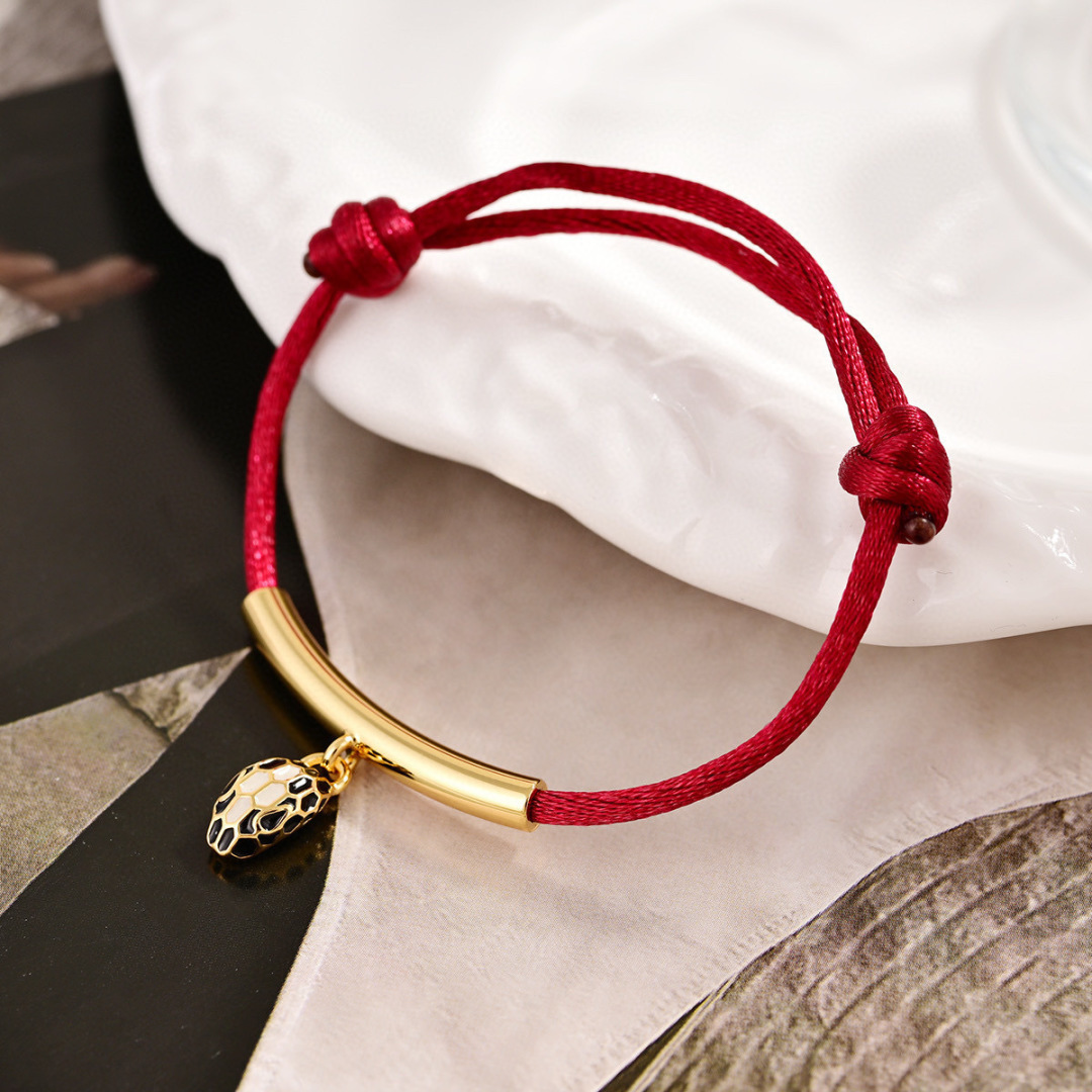 Bvlgari Serpenti Forever bracelet Gold-tone metal red cord black and white enamel snake head charm Adjustable red cord fits 15-19cm wrist