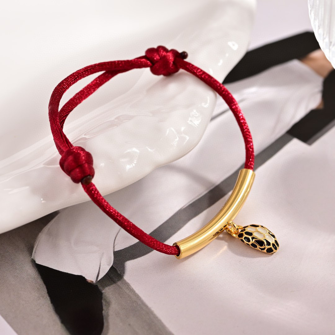 Bvlgari Serpenti Forever bracelet Gold-tone metal red cord black and white enamel snake head charm Adjustable red cord fits 15-19cm wrist