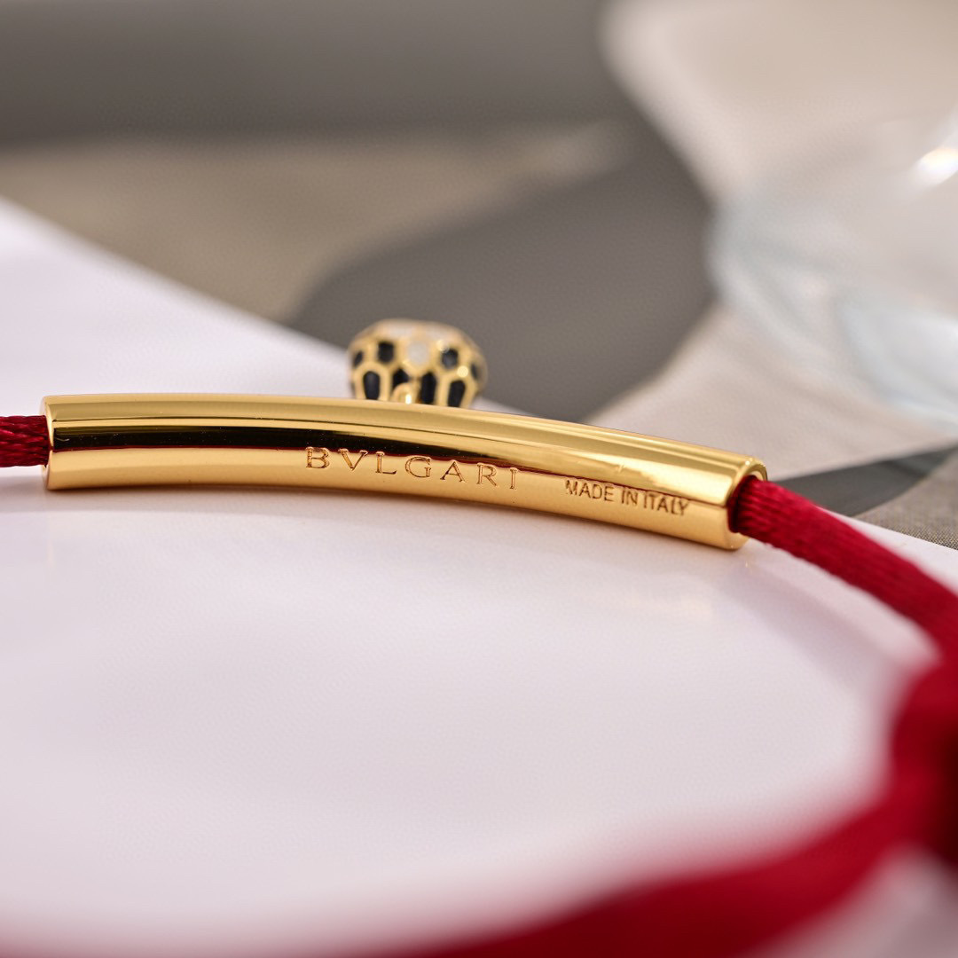 Bvlgari Serpenti Forever bracelet Gold-tone metal red cord black and white enamel snake head charm Adjustable red cord fits 15-19cm wrist