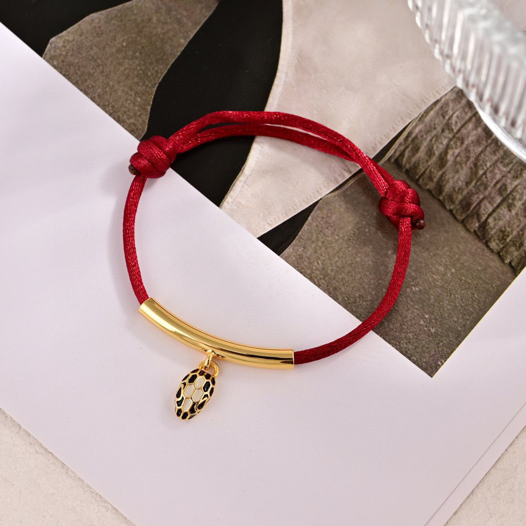 Bvlgari Serpenti Forever bracelet Gold-tone metal red cord black and white enamel snake head charm Adjustable red cord fits 15-19cm wrist
