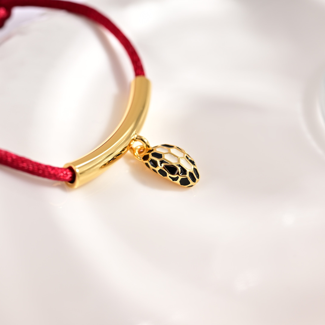 Bvlgari Serpenti Forever bracelet Gold-tone metal red cord black and white enamel snake head charm Adjustable red cord fits 15-19cm wrist