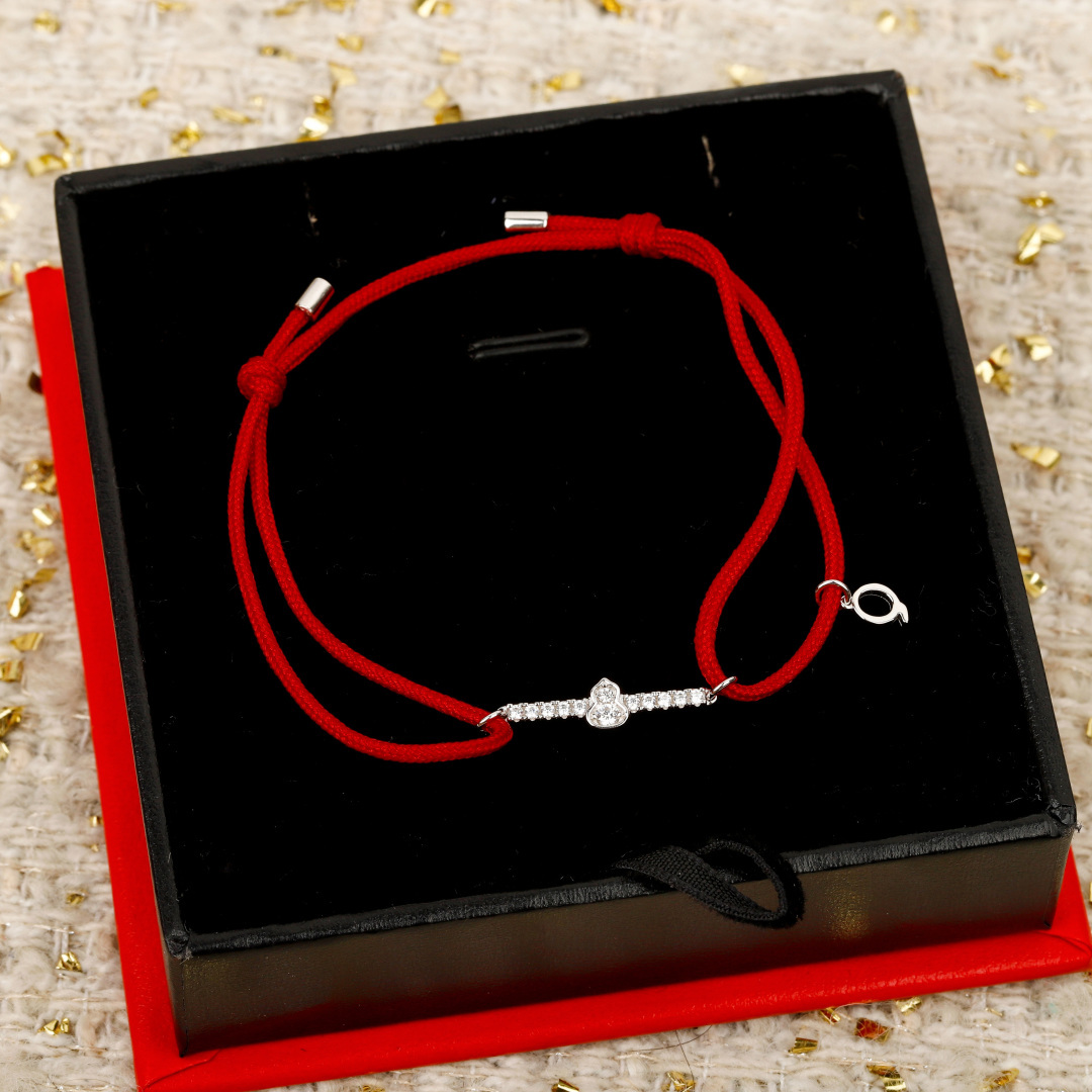 Qeelin Wulu Mini Solitaires bracelet Red cord with 18K gold rose gold white gold options and clear diamond accents Adjustable sliding knot fits 15-19cm wrist