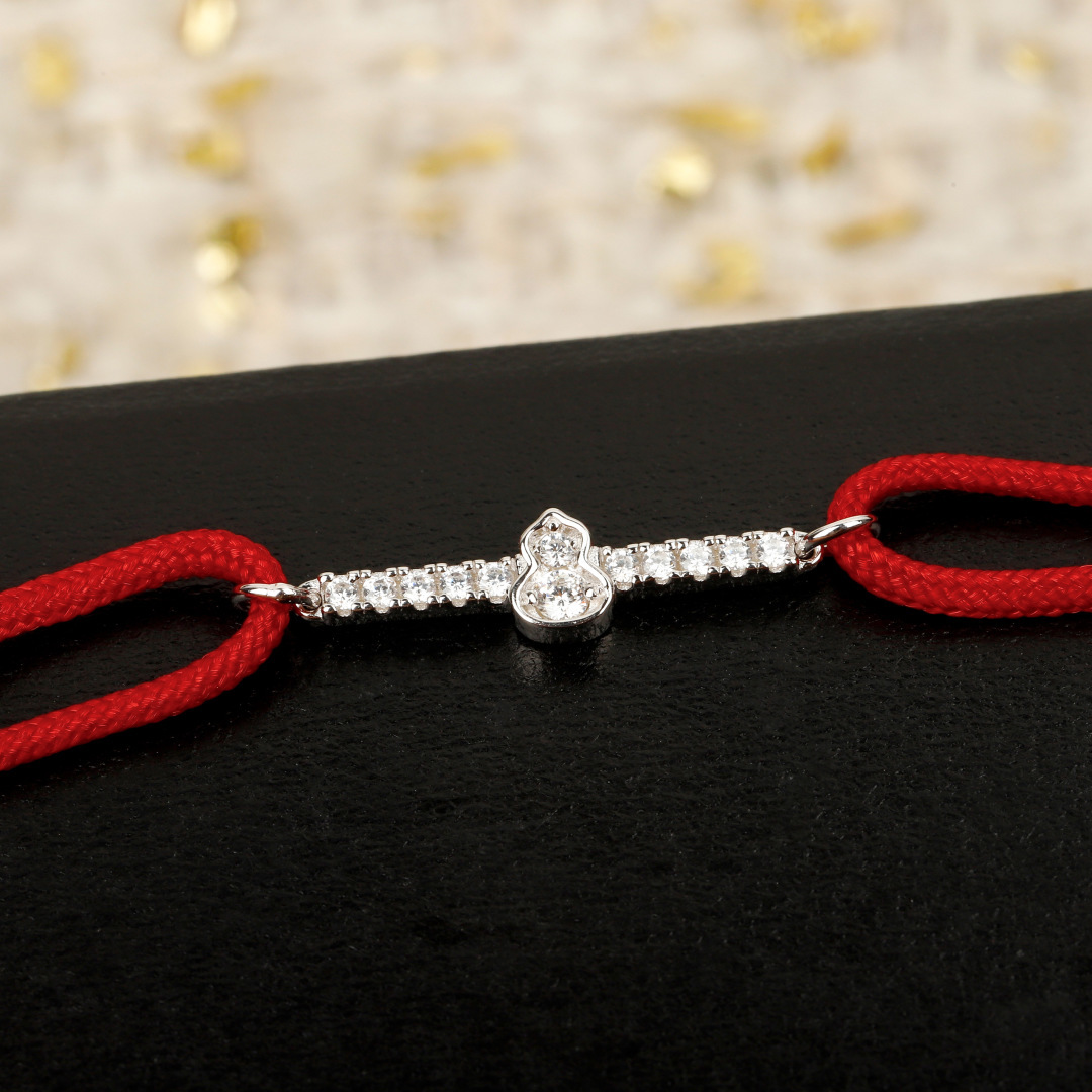 Qeelin Wulu Mini Solitaires bracelet Red cord with 18K gold rose gold white gold options and clear diamond accents Adjustable sliding knot fits 15-19cm wrist