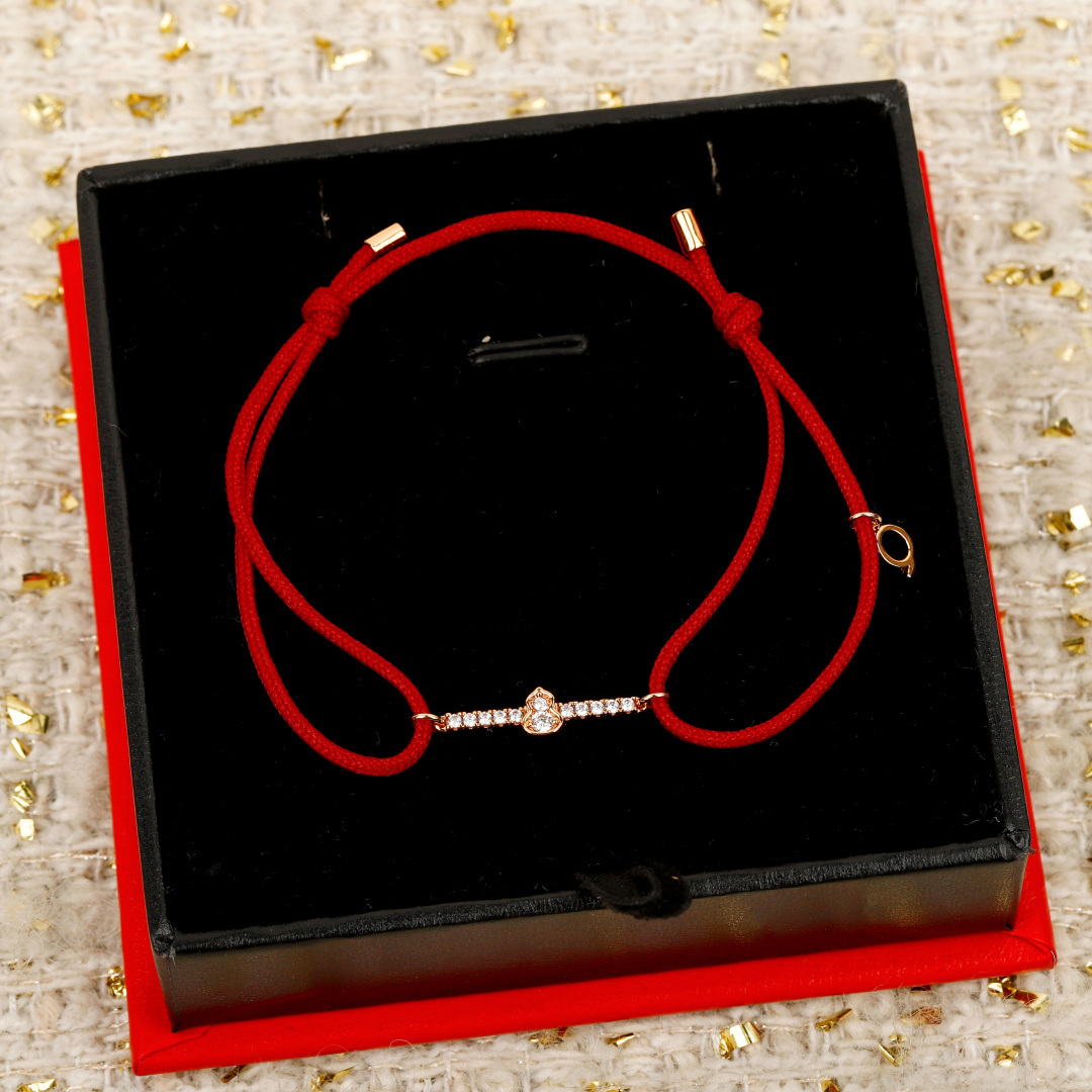 Qeelin Wulu Mini Solitaires bracelet Red cord with 18K gold rose gold white gold options and clear diamond accents Adjustable sliding knot fits 15-19cm wrist