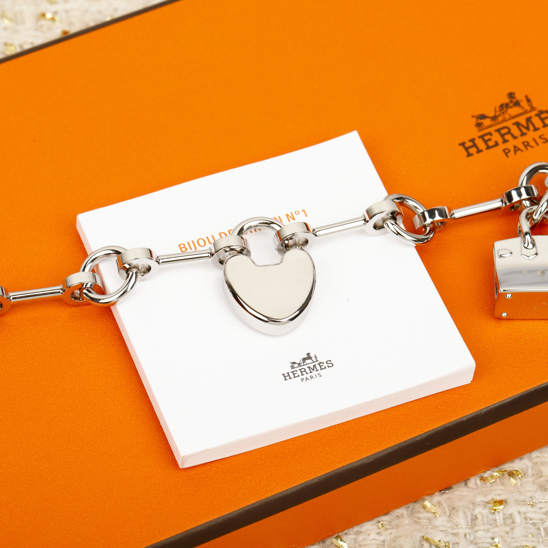 Bracciale Hermes Bijou de Birkin N 1 Metallo color argento con accenti in pelle arancione dettaglio smalto rosso ciondoli in argento 17 cm