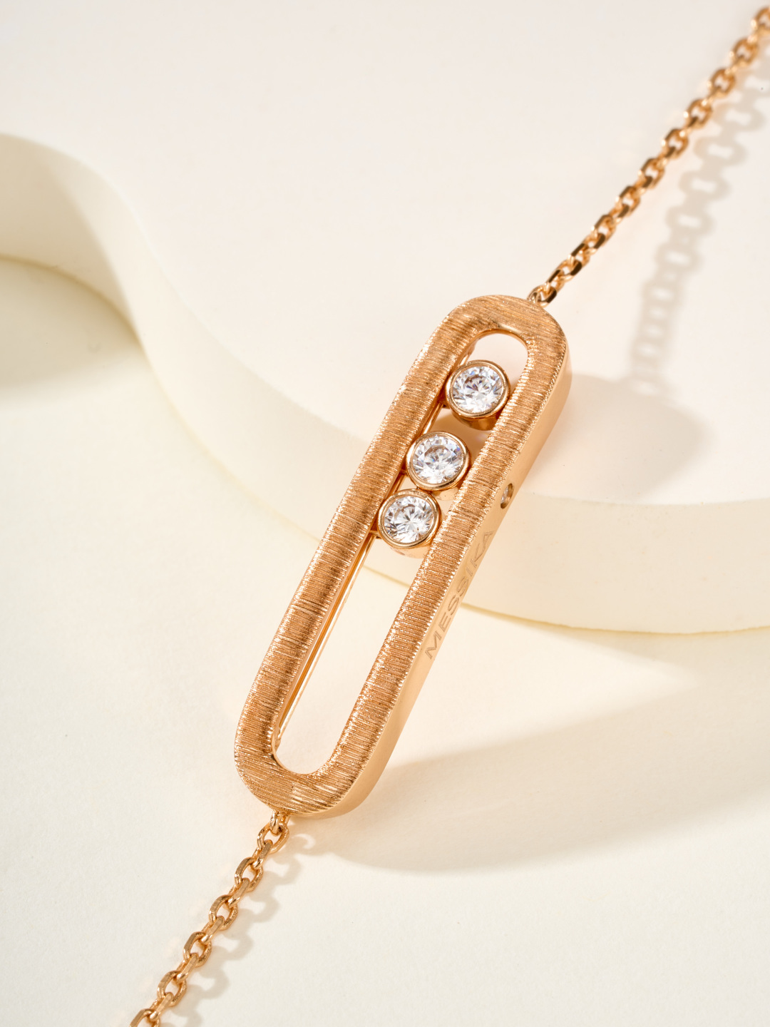 Messika Baby Move bracelet available in brushed silver-tone metal with clear round stones and brushed rose gold-tone metal with clear round stones adjustable 16-19cm