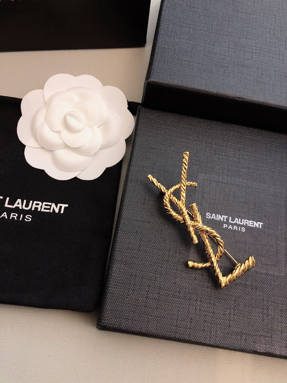 Saint Laurent Cassandre Twisted Monogram Brooch brooch gold-tone metal no accent stones 4 5cm width