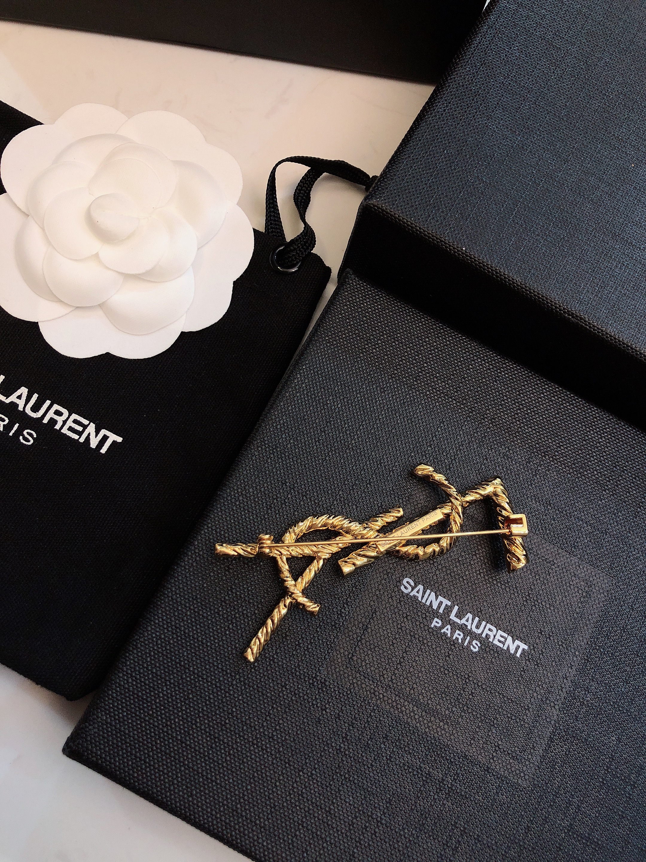 Saint Laurent Cassandre Twisted Monogram Brooch brooch gold-tone metal no accent stones 4 5cm width