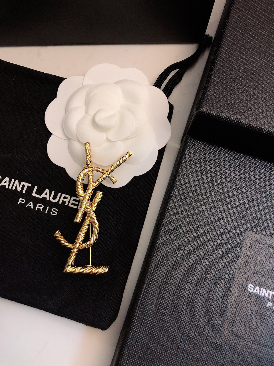 Saint Laurent Cassandre Twisted Monogram Brooch brooch gold-tone metal no accent stones 4 5cm width