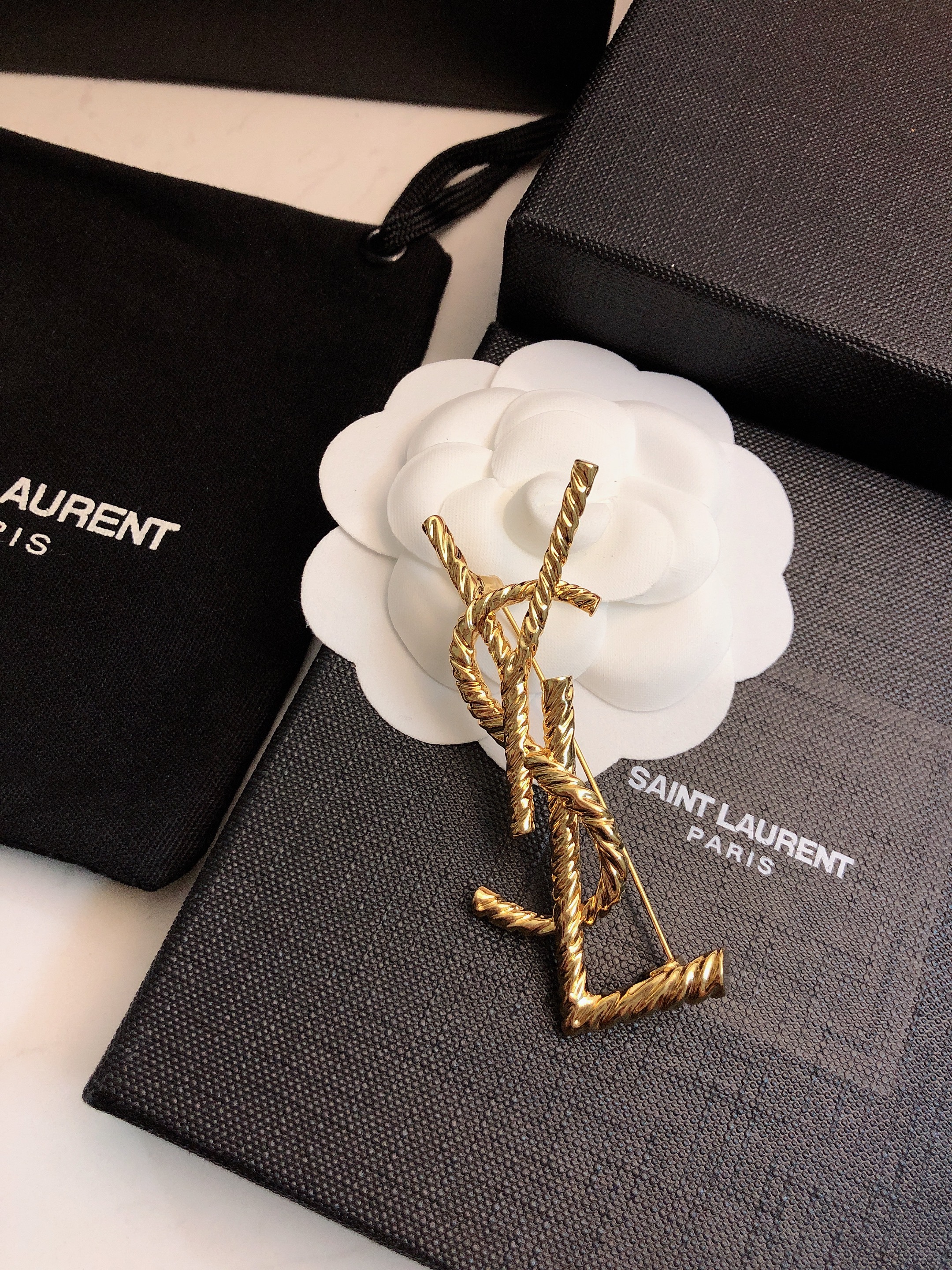 Saint Laurent Cassandre Twisted Monogram Brooch brooch gold-tone metal no accent stones 4 5cm width