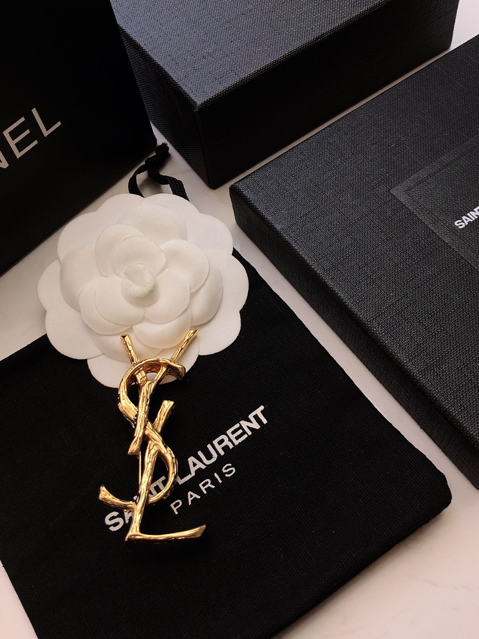 Saint Laurent Cassandre Twisted Monogram Brooch brooch gold tone metal no gemstones 4 5cm height