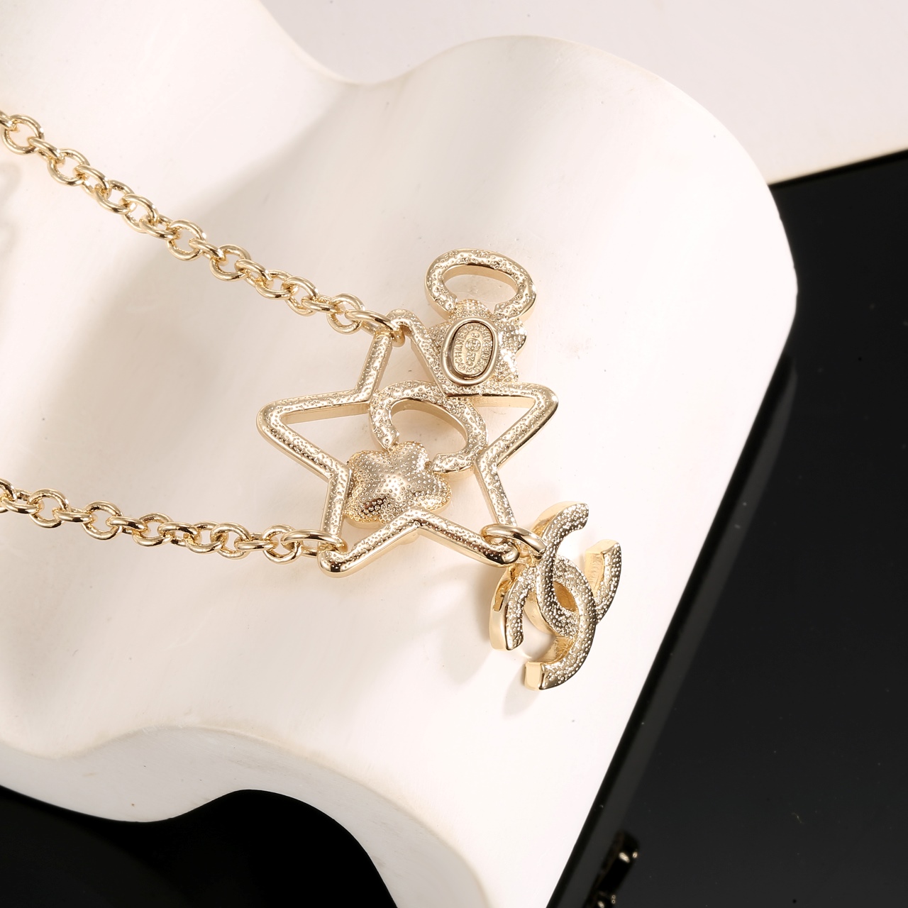 Chanel CC Star Charm necklace gold-tone metal with clear crystals pink and yellow star accents 42cm with 5cm extender
