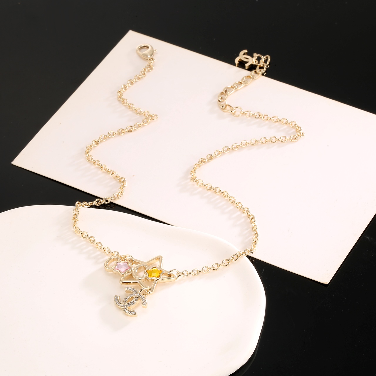 Chanel CC Star Charm necklace gold-tone metal with clear crystals pink and yellow star accents 42cm with 5cm extender