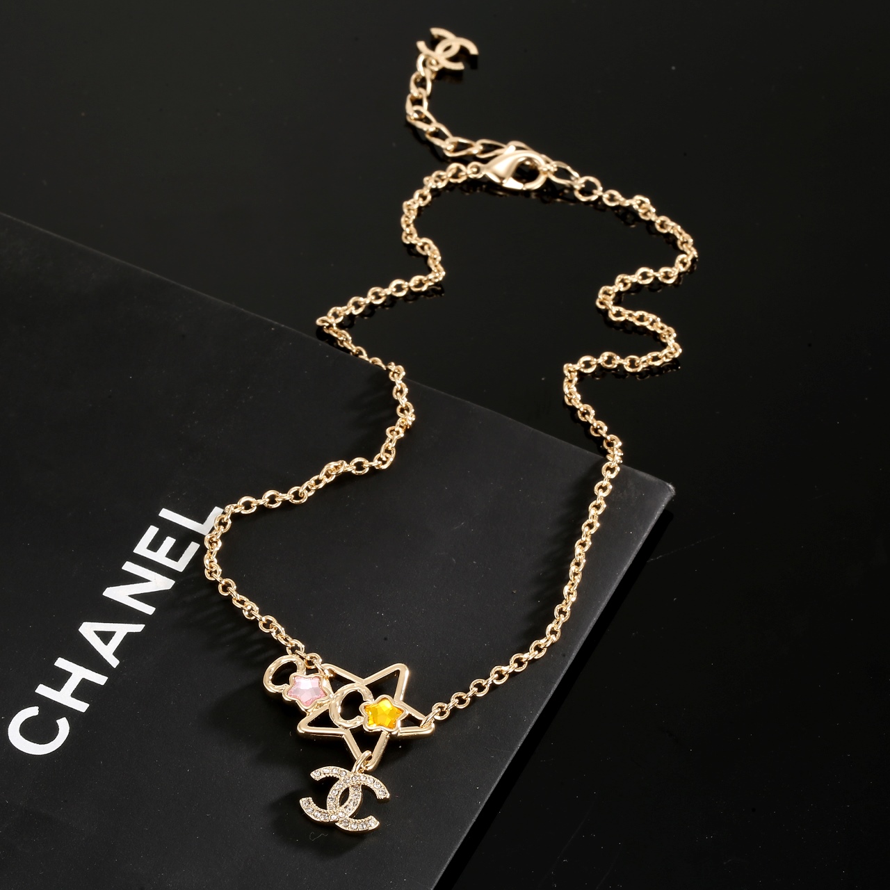 Chanel CC Star Charm necklace gold-tone metal with clear crystals pink and yellow star accents 42cm with 5cm extender