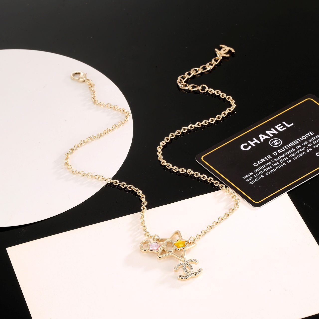 Chanel CC Star Charm necklace gold-tone metal with clear crystals pink and yellow star accents 42cm with 5cm extender