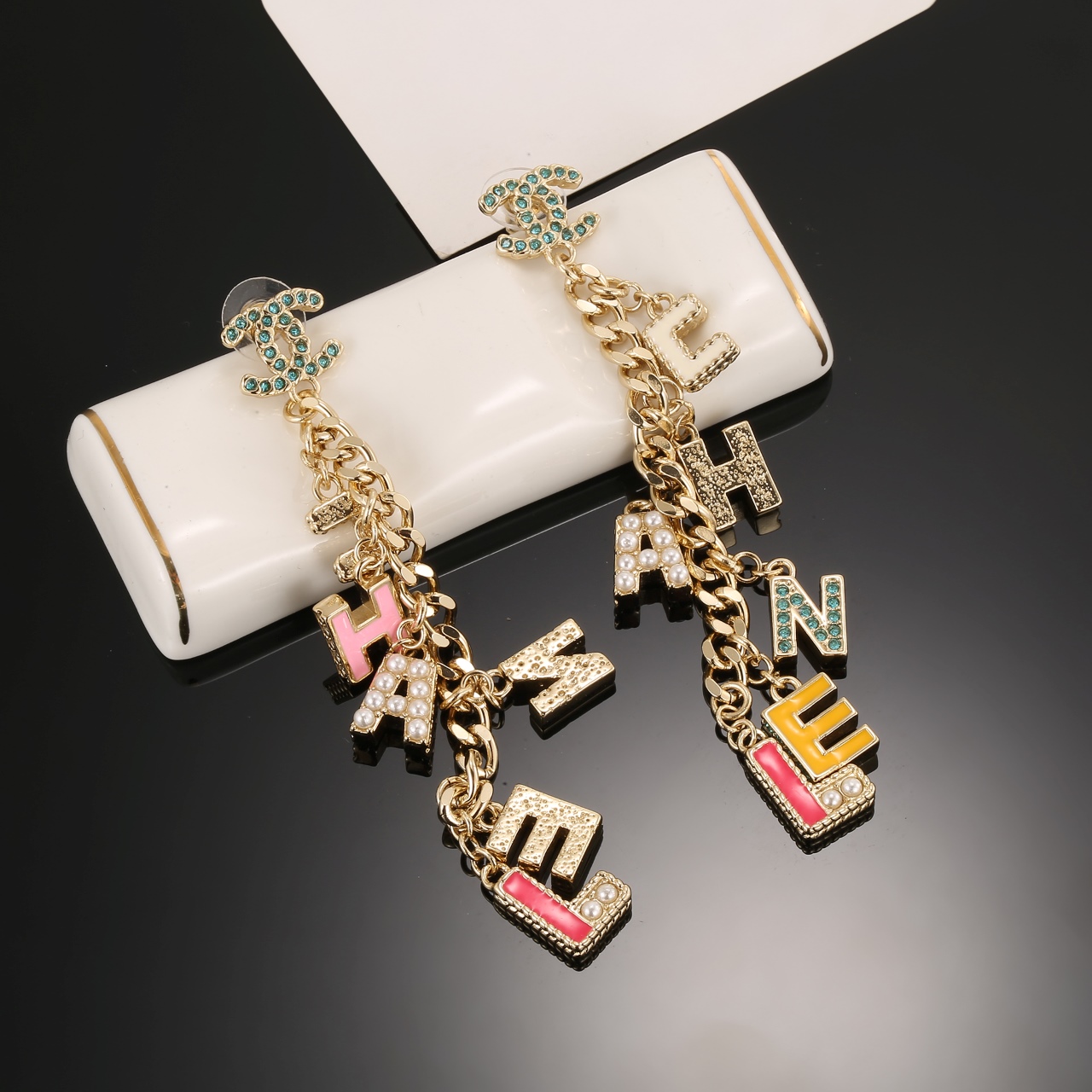 Chanel CHANEL Letter Charm CC Drop Earrings earrings Gold-tone metal with green crystals white faux pearls cream pink yellow and pink enamel letter charms 8cm drop length