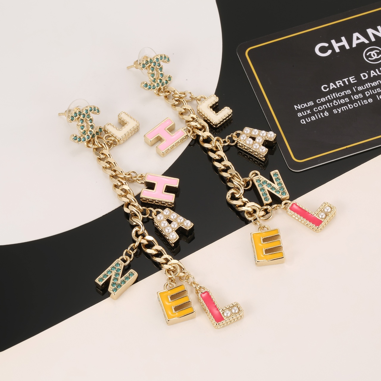 Chanel CHANEL Letter Charm CC Drop Earrings earrings Gold-tone metal with green crystals white faux pearls cream pink yellow and pink enamel letter charms 8cm drop length
